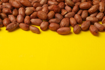 Tasty peanut on yellow background, space for text. Vitamin food