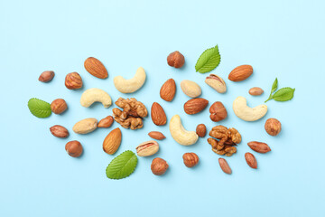 Different nuts on blue background, top view. Vitamin food
