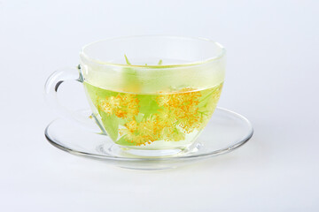 Transparent glass cup of tea with linden isolated on white