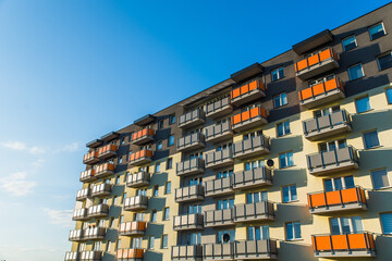 Exterior of modern residential apartment building with balconies on housing estate. Urban landscape...
