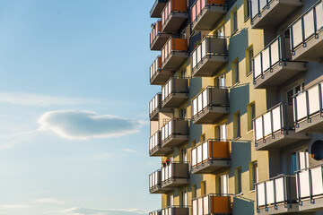 Exterior of modern residential apartment building with balconies on housing estate. Urban landscape...