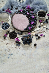 Sweet and tasty tart with fresh blueberries, blackberries and grapes, served on stone background