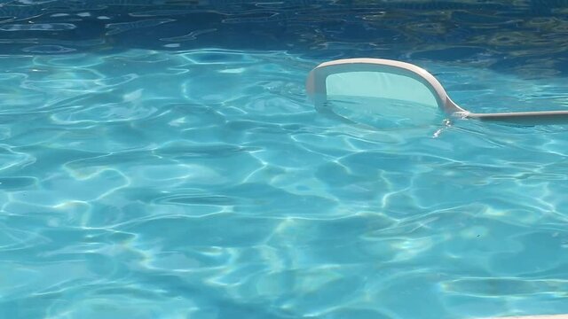 racket cleaning the pool water