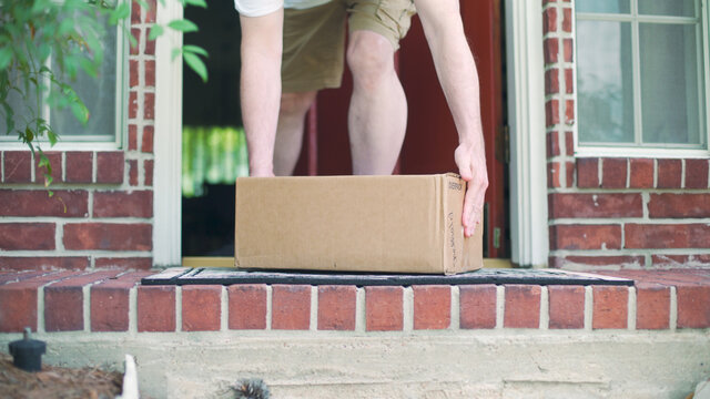 Man Opens His Front Door To Pickup A Delivery Left On His Porch