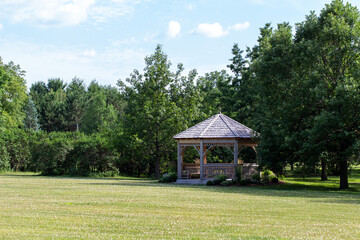 Scenic rural tree lined landscape with wooden gazebo