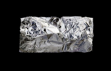 A piece of tin aluminum foil isolated on black background. Wrinkled aluminum foil.