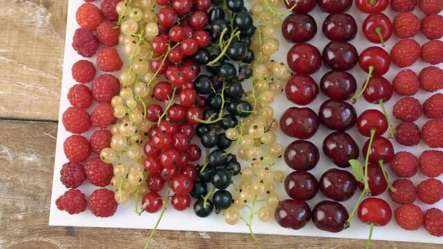 rows of assorted berries on a white board