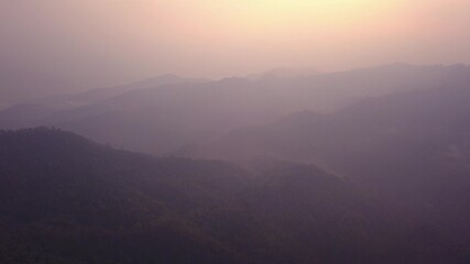 Beautiful sunrise over wild forest mountains in morning in Laos . Aerial Video flying over mountains.