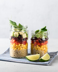 quinoa, corn, bean and avocado salad in a jar. Healthy food concept