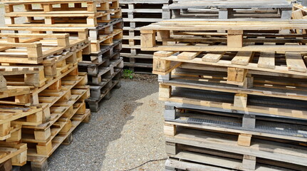 stacked wooden pallets. Wooden production pallets stand piled in a pile. Close-up.