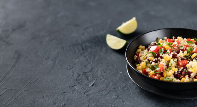 mexican quinoa bowl on a dark background, place for text