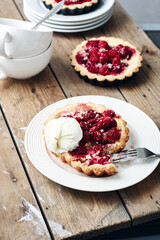 Baked mini tarts with raspberries.