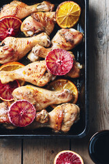 Baked chicken drumstick with orange.