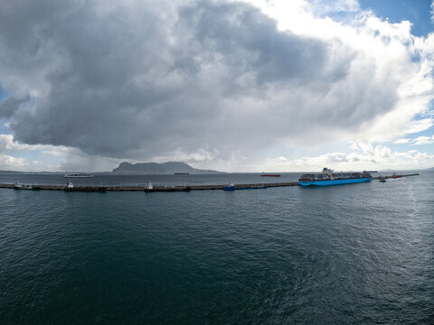 Brake water pier in the Algeciras / Spain and Gibraltar Rock on the background. One container ship alongside to the pier.