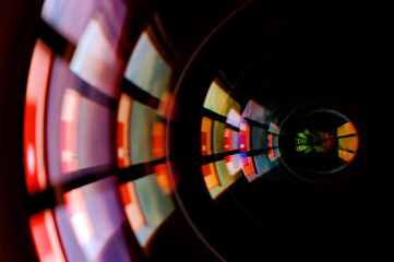 Macro shot of front element of a camera lens with beautiful color lights reflections