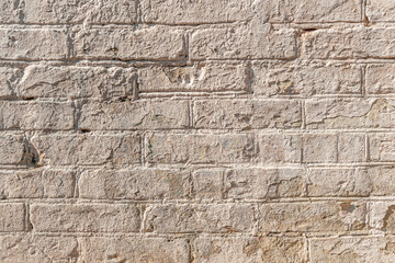 abstract background of an old brick wall painted beige close up