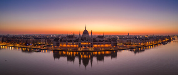 Fototapeta na wymiar Panoramic aerial drone shot of Hungarian Parliament lights off sunrise in Budapest dawn