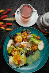 Hearty breakfast with cheesecakes, meat, berries, sauce in a top restaurant
