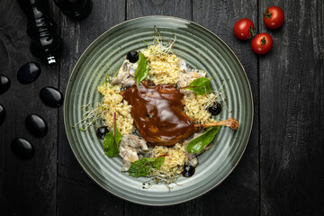 Duck legs confit with potato gratin and mushroom sauce. Restaurant serving. Copy space. Top view
