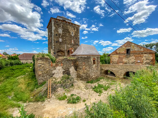 Fototapeta na wymiar ruins of a gothic dam with a tower and a stone bridge Hradenin in Central Bohemia