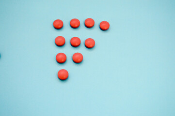 pink pills, medicines for coronavirus in geometric shape. medicines for treating humans and preventing the virus. many beautiful pills taken from the top