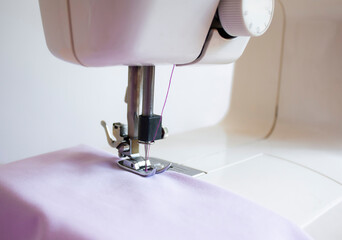 abric lies on the working area of ​​an electric sewing machine