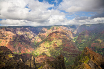 Fototapeta na wymiar Waimea Canyon, also known as the Grand Canyon of the Pacific, is a large canyon, approximately ten miles long and up to 3,000 feet deep, Kauai, Hawaii