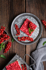 Sweet red currant dessert filled with cream cheese, decorated with fresh berries