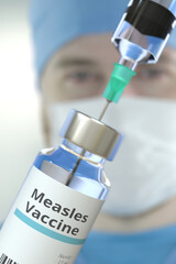 Medical bottle with measles vaccine and syringe against blurred doctor's face, 3D rendering