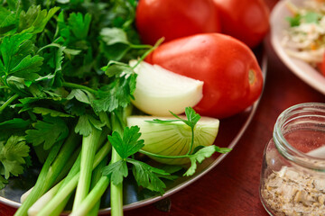 healthy food - fresh vegetables on a wooden background, tomatoes and greens