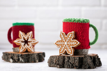Knitted winter cup with gingerbread christmas cookies