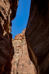 Dramatic cliffs loom over the canyon in Petra