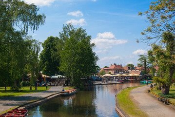 Fototapeta na wymiar Panorama of the city Lübbenau/ Spreewald, Germany on a sunny day. View of the canal and the boat.