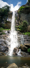 Fototapeta na wymiar Giant tropical waterfall in the mountains, Sri Lanka. Bookmark/panoramic format