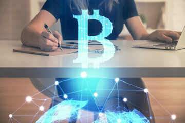 Double exposure of woman hands typing on computer and crypto market theme hologram drawing....