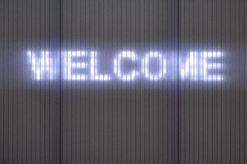 WELCOME. Writing on a Wall with illuminated lettering.