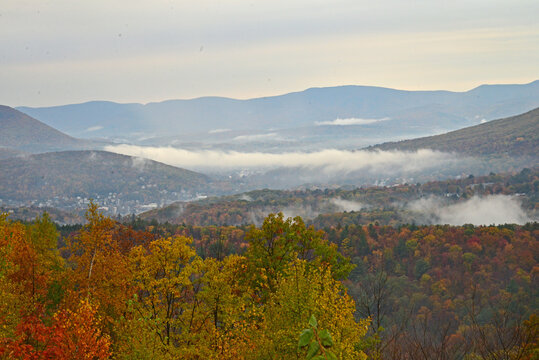 Mist rises from the valleys in the countryside around the Veterans War Memorial Tower in Massachusetts.