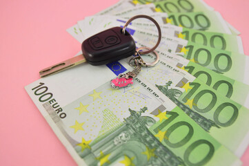 car keys lie on green banknotes with a nominee of 100 euros