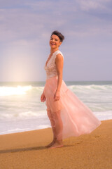 Fototapeta na wymiar Romantic young girl posing on the beach. Beautiful models portrait. Soft background