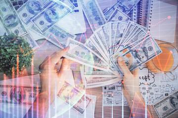 Multi exposure of financial graph drawing hologram and USA dollars bills and man hands. Analysis concept.