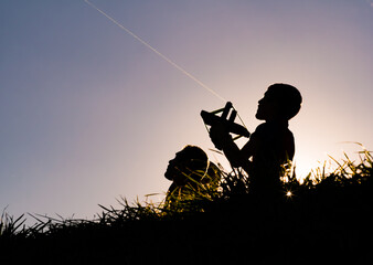 A boy flies a kite with his family