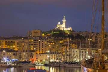 Marseille, France panorama at night. The famous european harbour view with the Notre Dame de la Garde