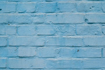 blue painted brick wall shot perpendicularly close up