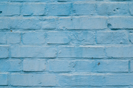 blue painted brick wall shot perpendicularly close up
