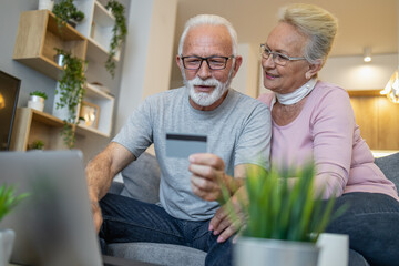 Senior couple shopping on internet