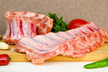 raw pork ribs on a wooden board