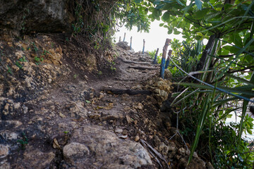 Stairs leading to top of hidden hill for great view at Batu Bengkung Beach Malang, East Java,...