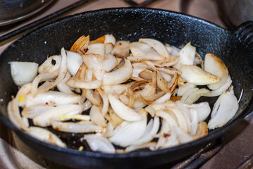 Frying onion. Minced onion in frying pan.selective focus.