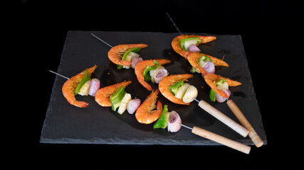 
Trio of delicious shrimp skewers, on a slate