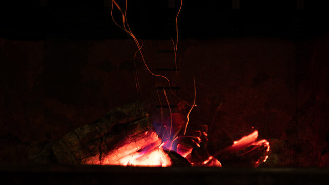 
Close up of a fire, in an old barbecue, at night